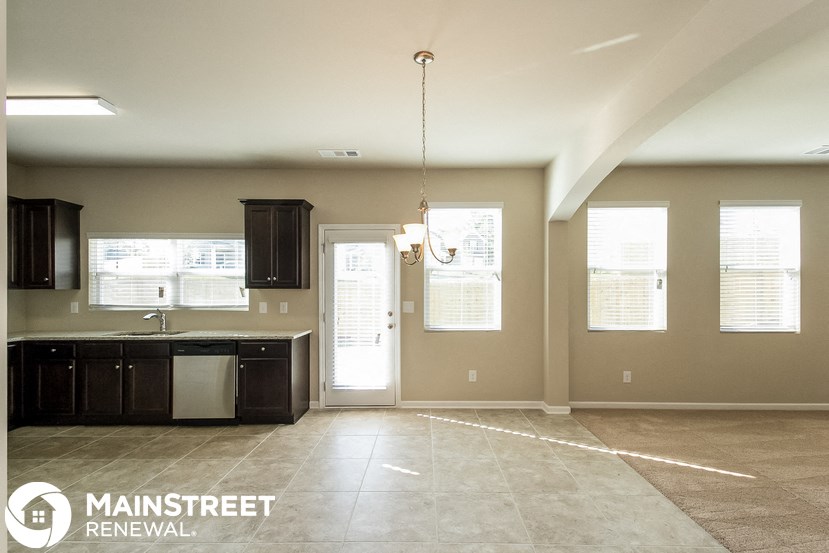 an empty kitchen with a sink and a window