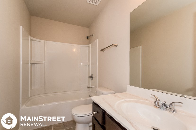 a bathroom with a sink and a toilet and a shower