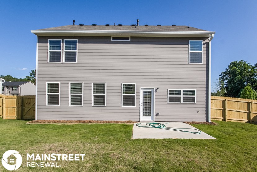 a with a yard and a hose on the ground