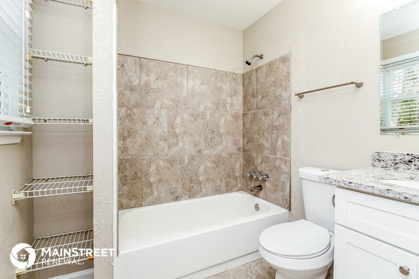 a bathroom with a tub and a toilet and a sink