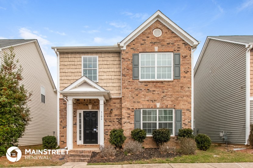 a brick house with a front porch and a black door