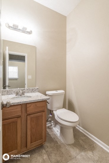 a bathroom with a toilet and a sink and a mirror