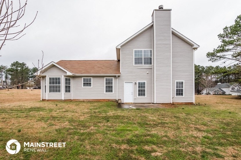 a white house with a yard in front of it