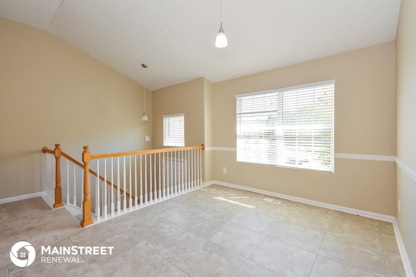 the upstairs loft has a large window and tile flooring