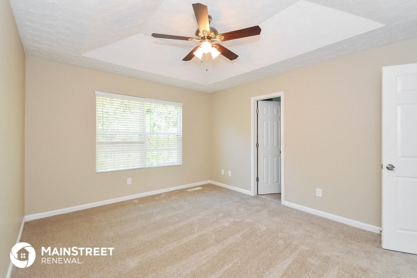 the master bedroom is spacious and has a ceiling fan