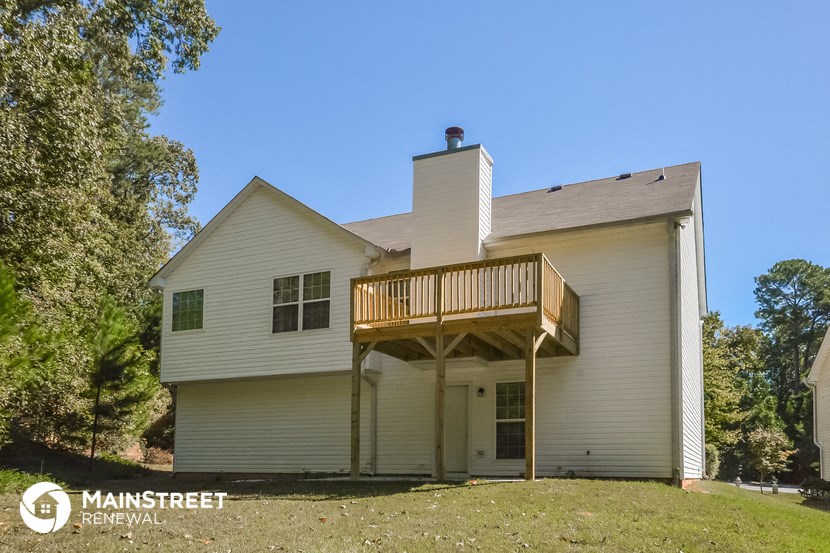 the view of the back of a house with a deck
