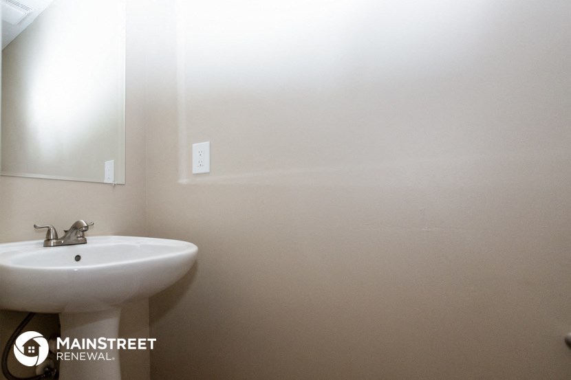 a white bathroom with a sink and a mirror