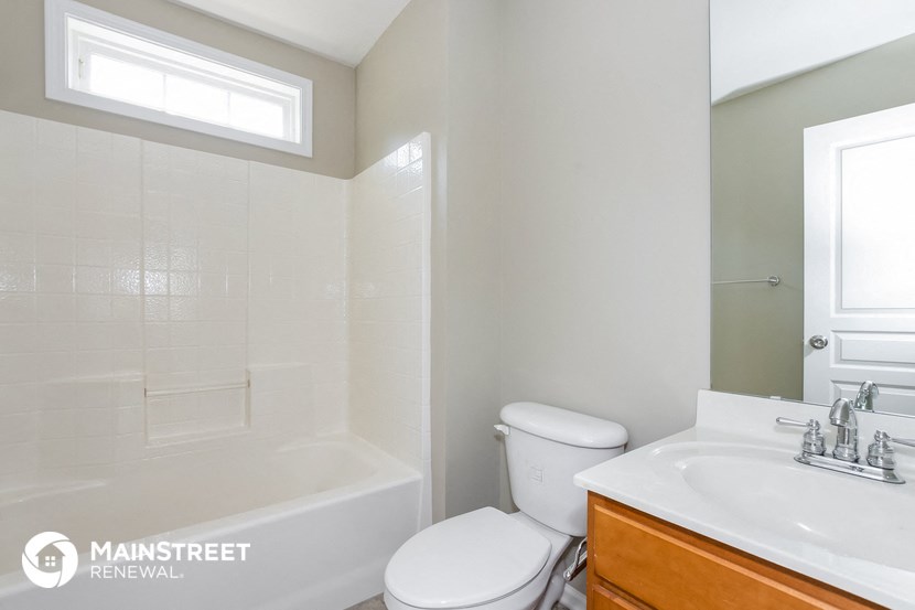 a bathroom with a toilet and a sink and a tub