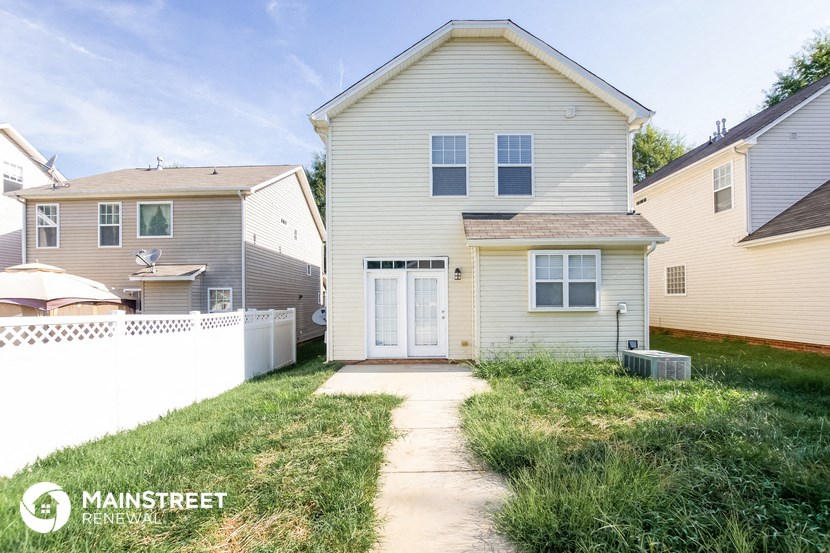 a white house with a yard and a white fence