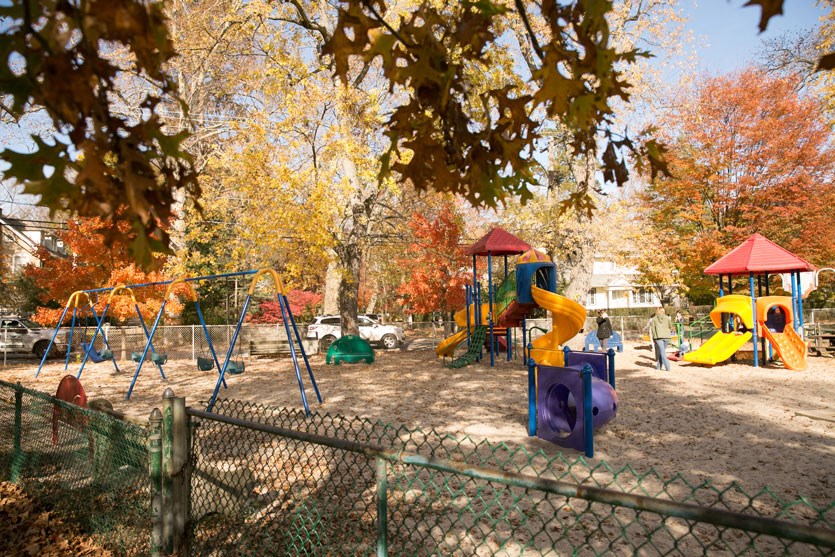 a playground with a slide and other toys in a park
