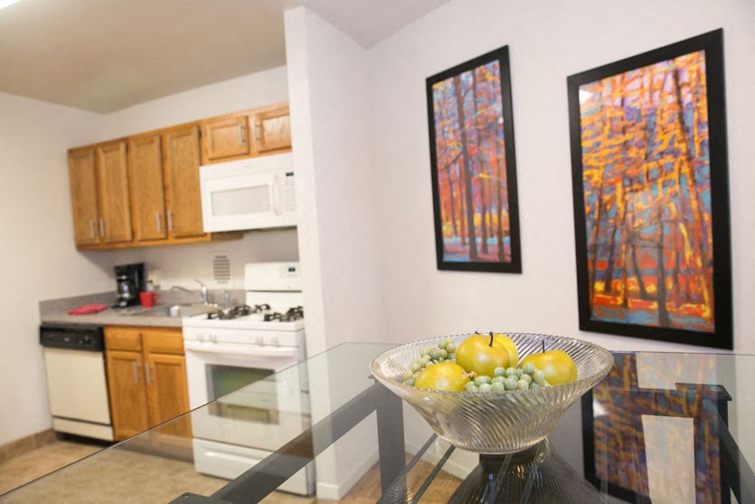 a kitchen with a bowl of fruit on a table