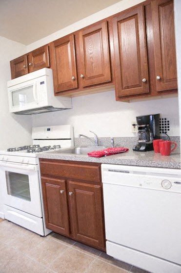 a kitchen with a white stove and a microwave
