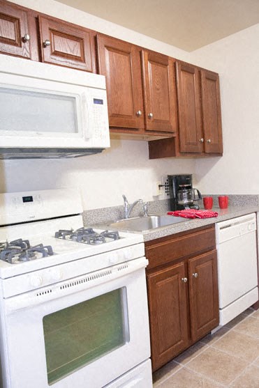 a kitchen with a stove and a sink and a microwave