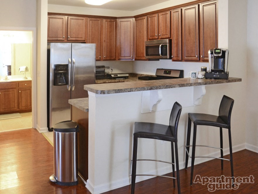 a kitchen with a counter and two bar stools