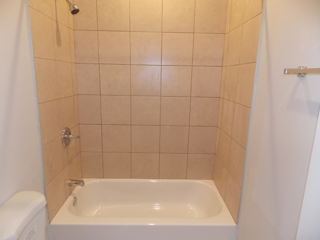 a small bathroom with a shower and a sink