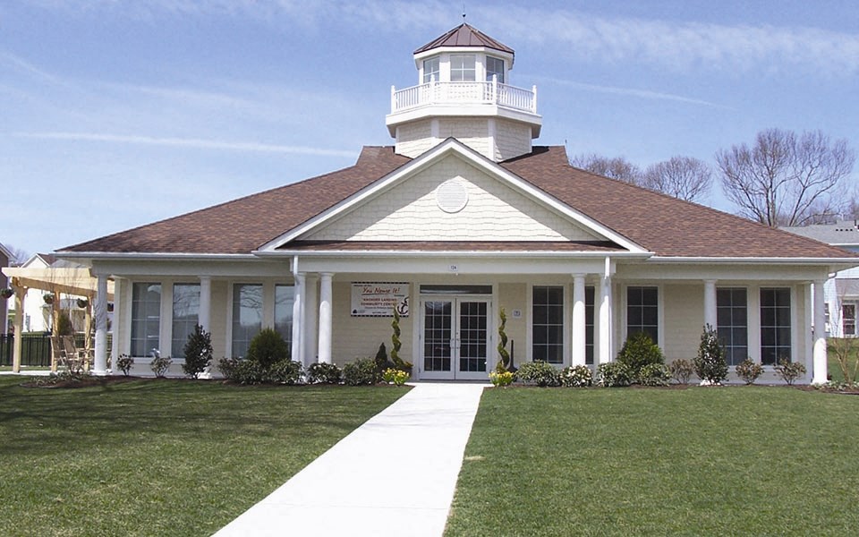 a white house with a light house on top of it