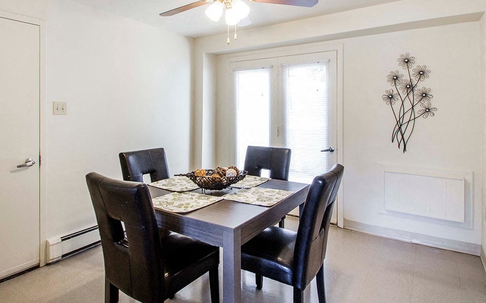 a dining room with a table and chairs