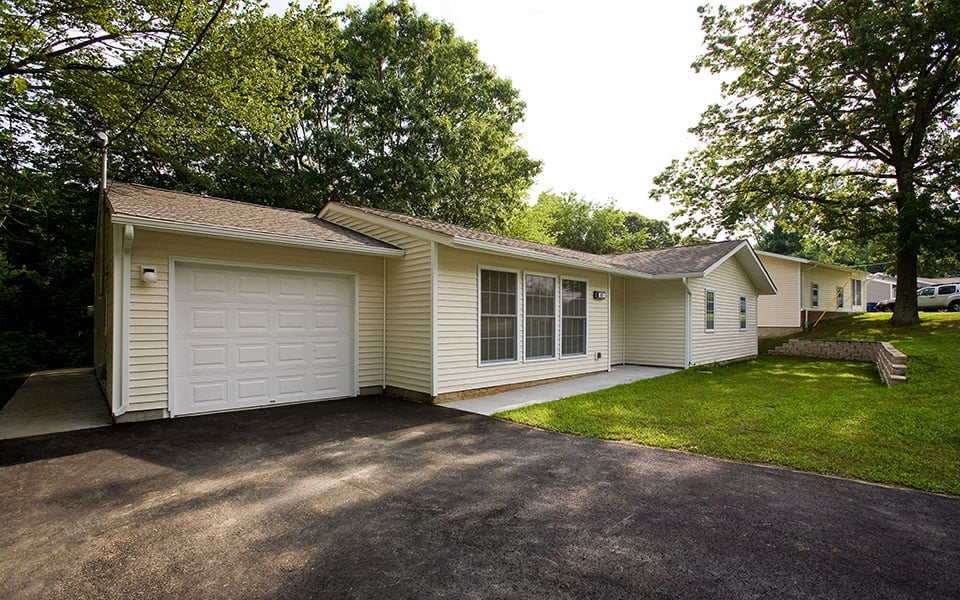 a white house with a white garage and a driveway
