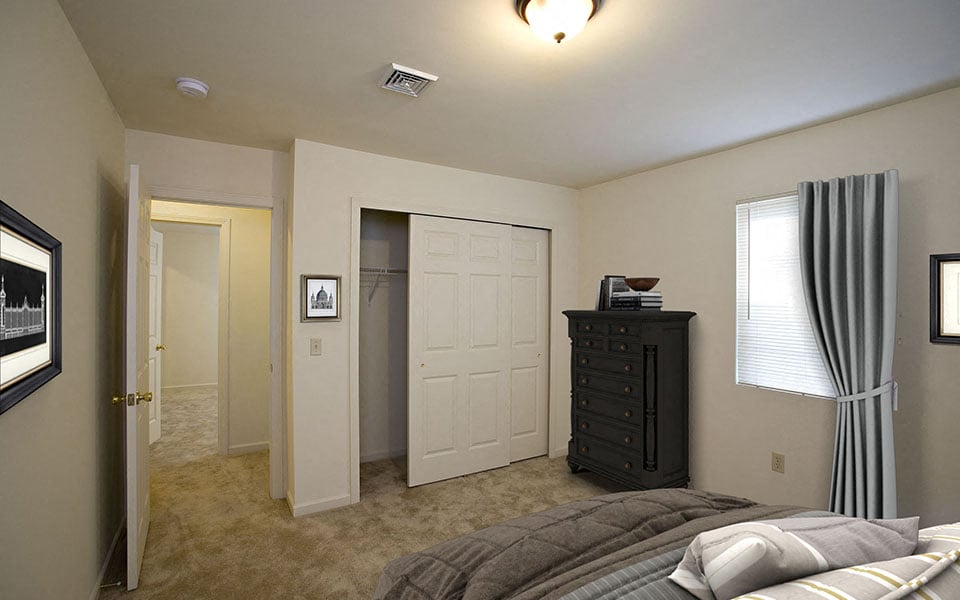 a bedroom with a bed and a dresser