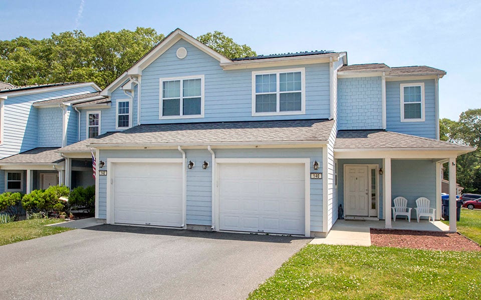 a blue house with a white garage door