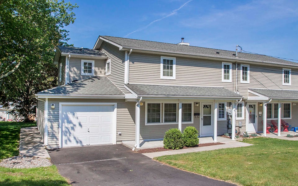 a house with a white garage door and a driveway