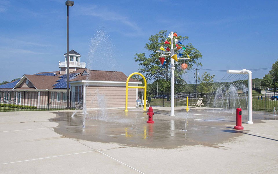 a fire hydrant spewing water in a park