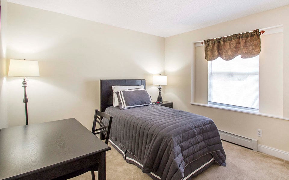 a bedroom with a bed and a table