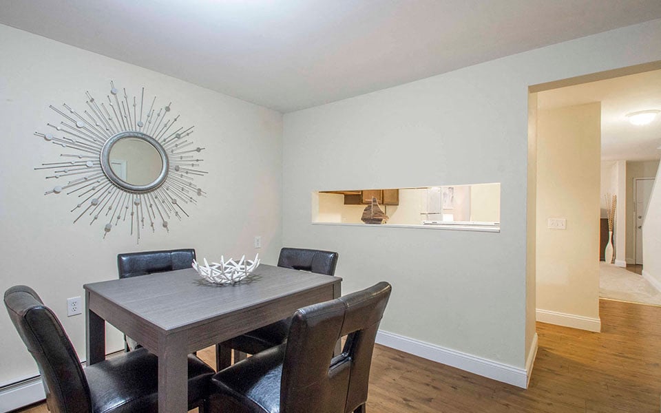 a dining room with a table and chairs