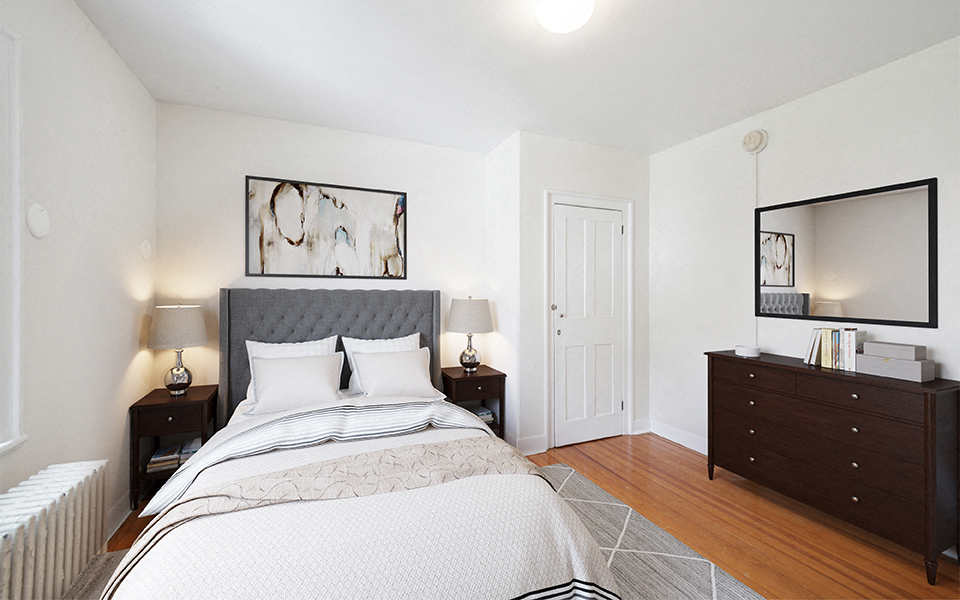 a bedroom with a bed and a mirror on the wall