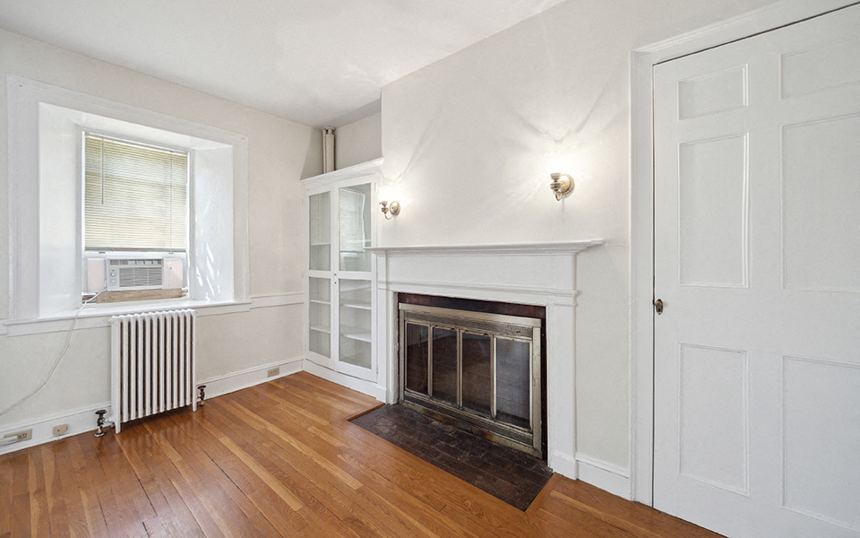 a living room with a fireplace and a window