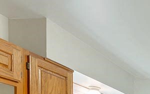CoddingtonCove a kitchen with wooden cabinets and a black refrigerator