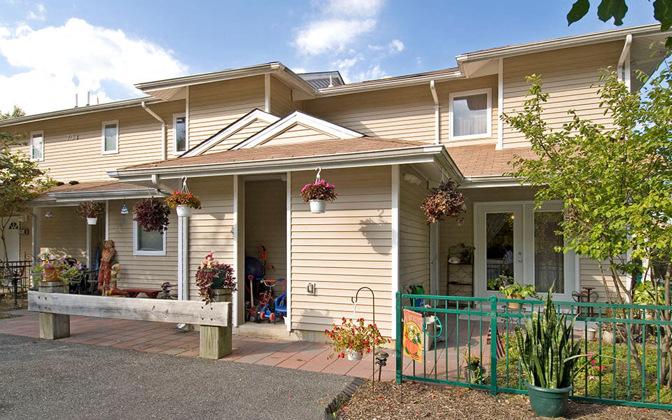 a house with a porch and flowers on it