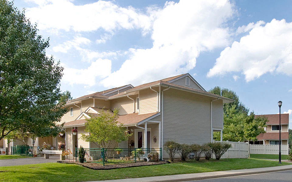a house with a yard and a street in front of it