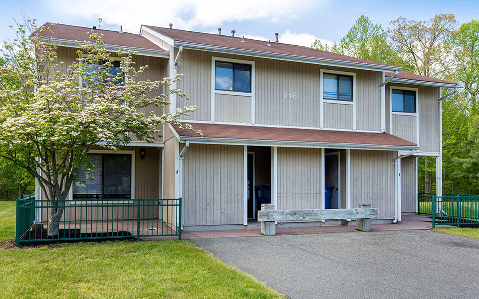 a white house with a bench in front of it