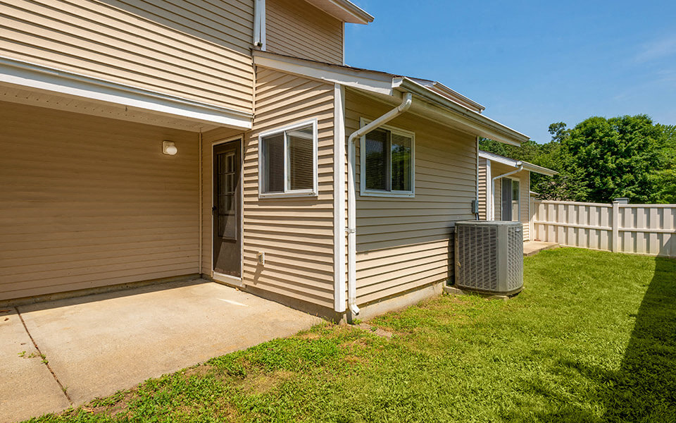the front of a house with a sidewalk and a yard