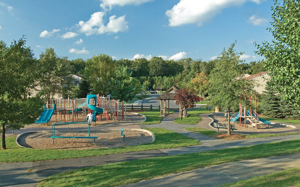 a playground in a park with trees