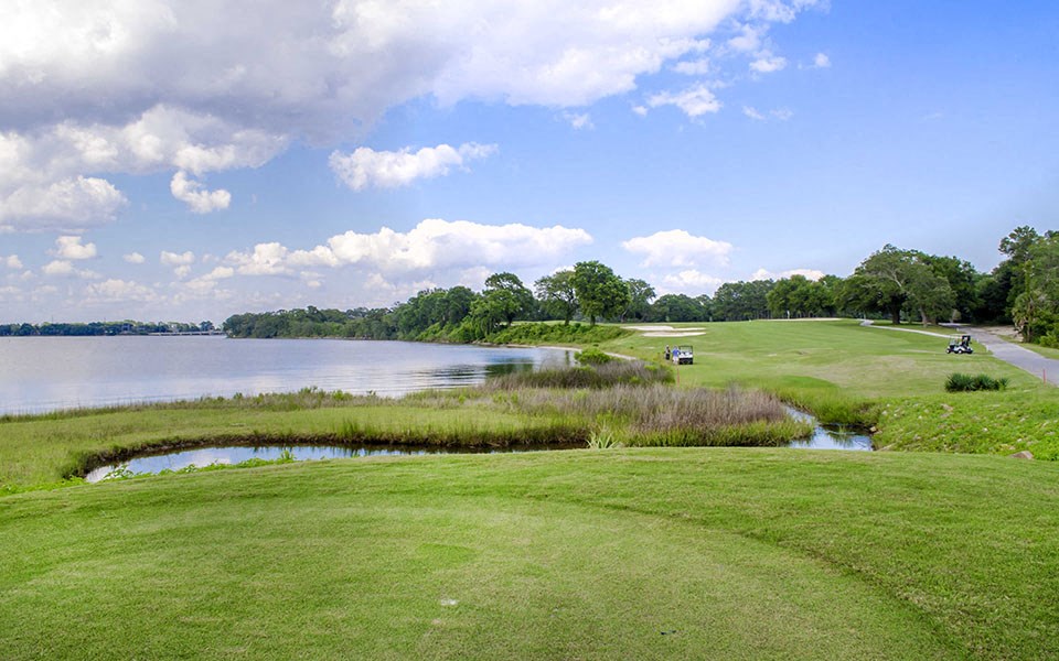 a golf course next to a body of water