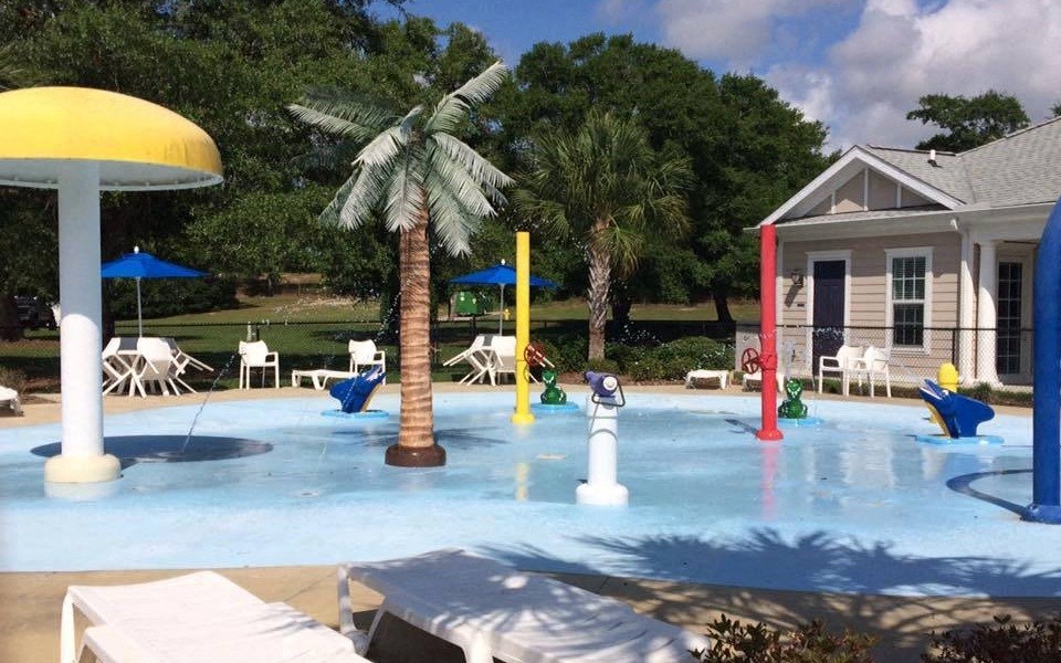 a swimming pool at a home with a house and palm trees