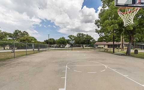 the basketball court is equipped with a basketball hoop and a net