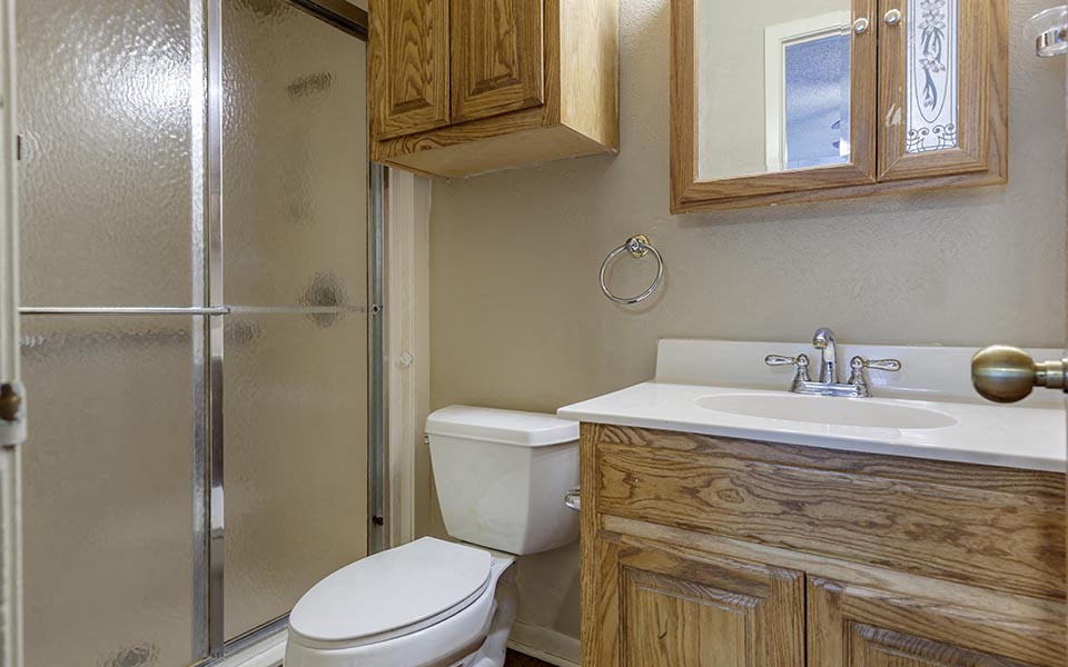 a bathroom with a toilet and a sink and a shower