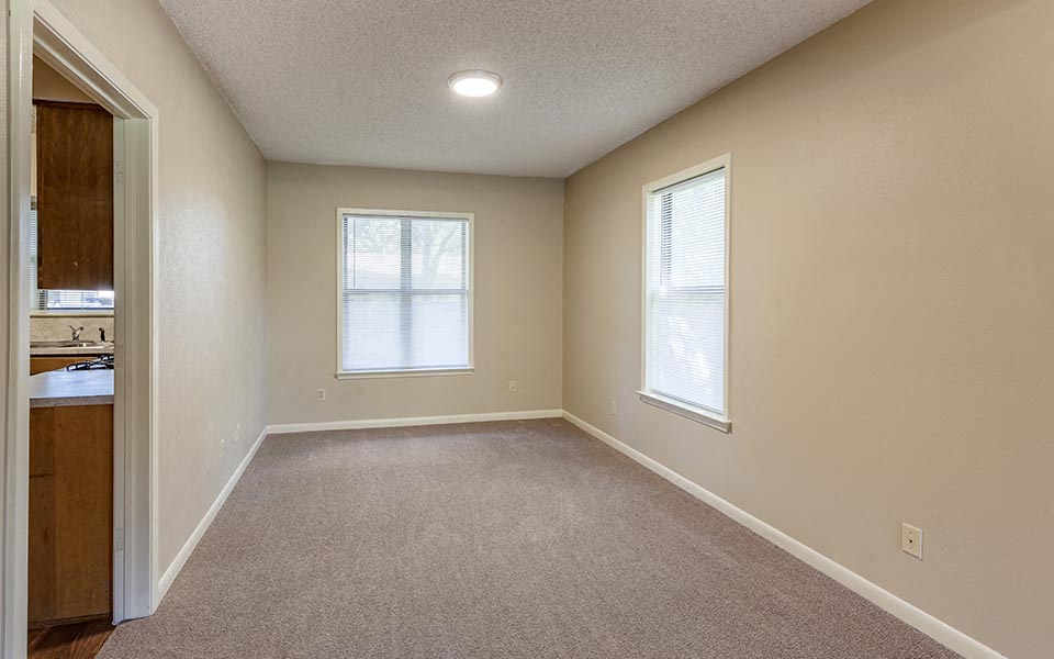 an empty room with a sink and a window