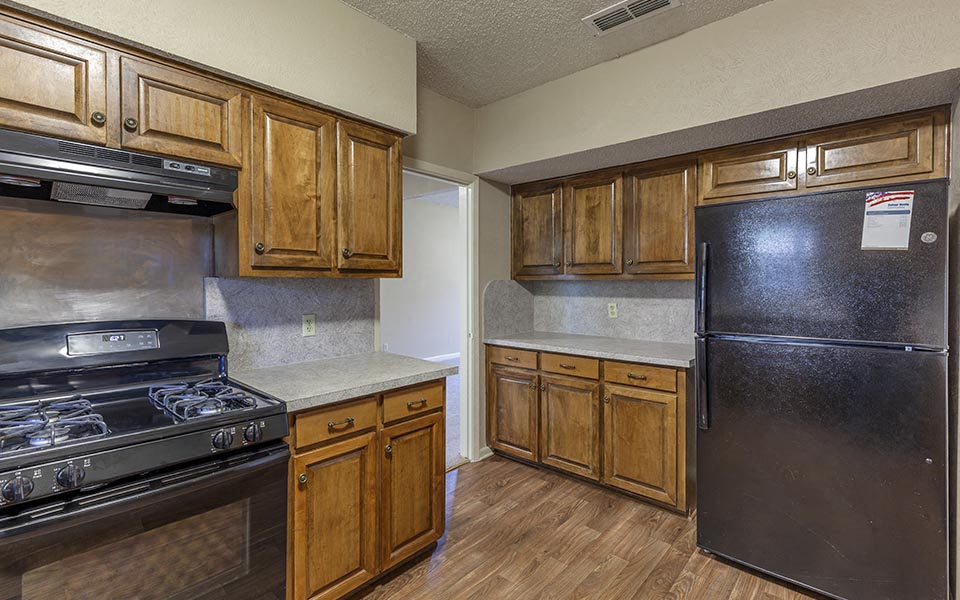 a kitchen with a stove and a refrigerator
