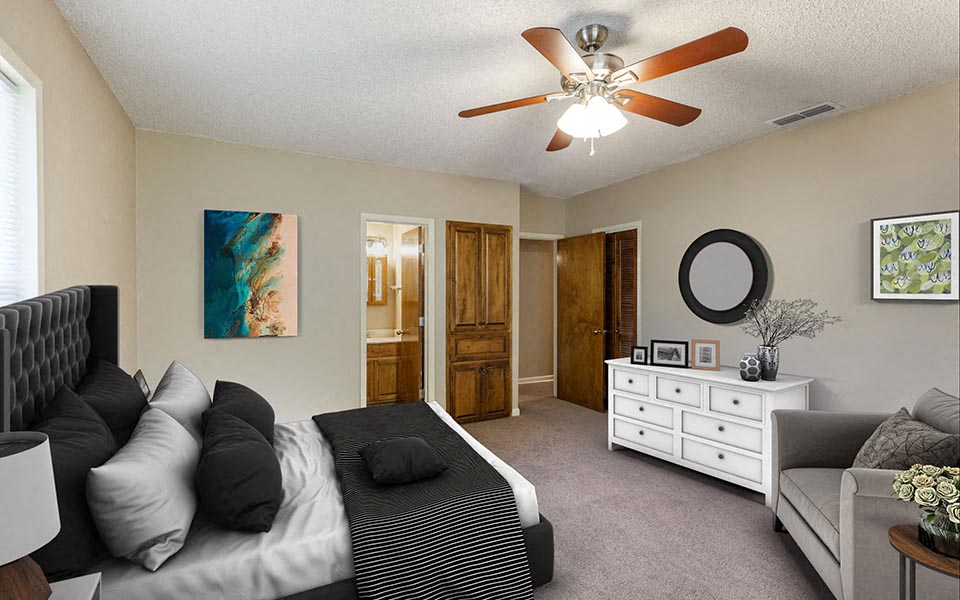 a bedroom with a bed and a ceiling fan