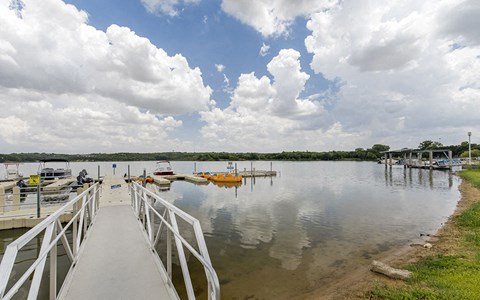 a dock on a lake with boats in the water
