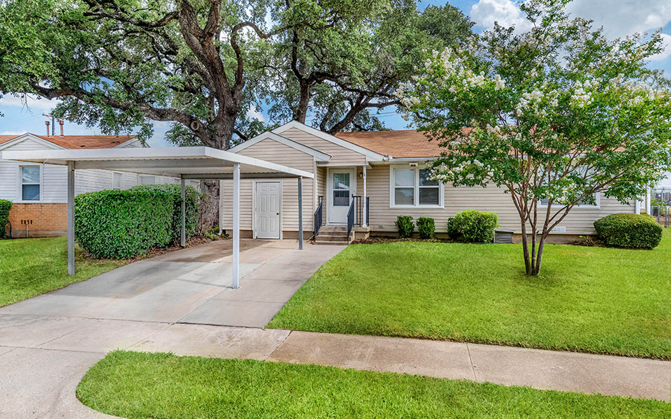 a white house with a yard and a sidewalk