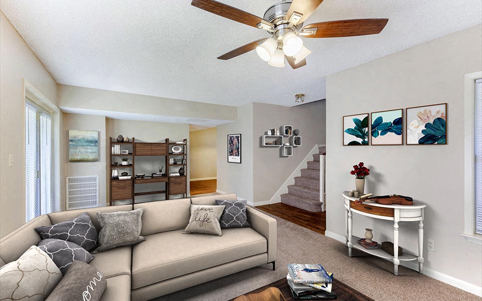a living room with a couch and a ceiling fan