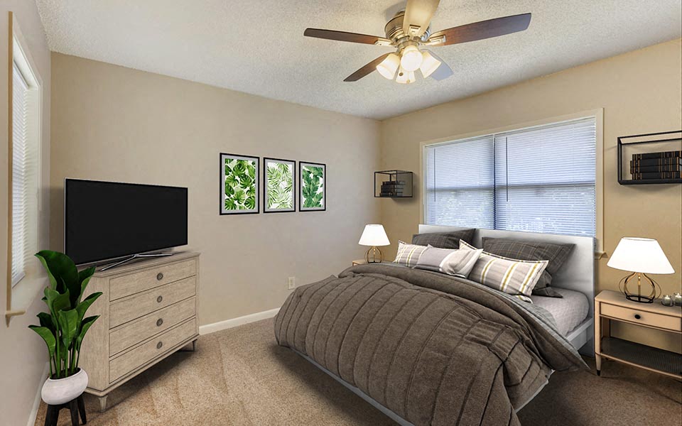 a bedroom with a bed and a ceiling fan