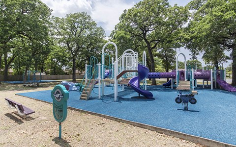 a playground with slides and other toys in a park