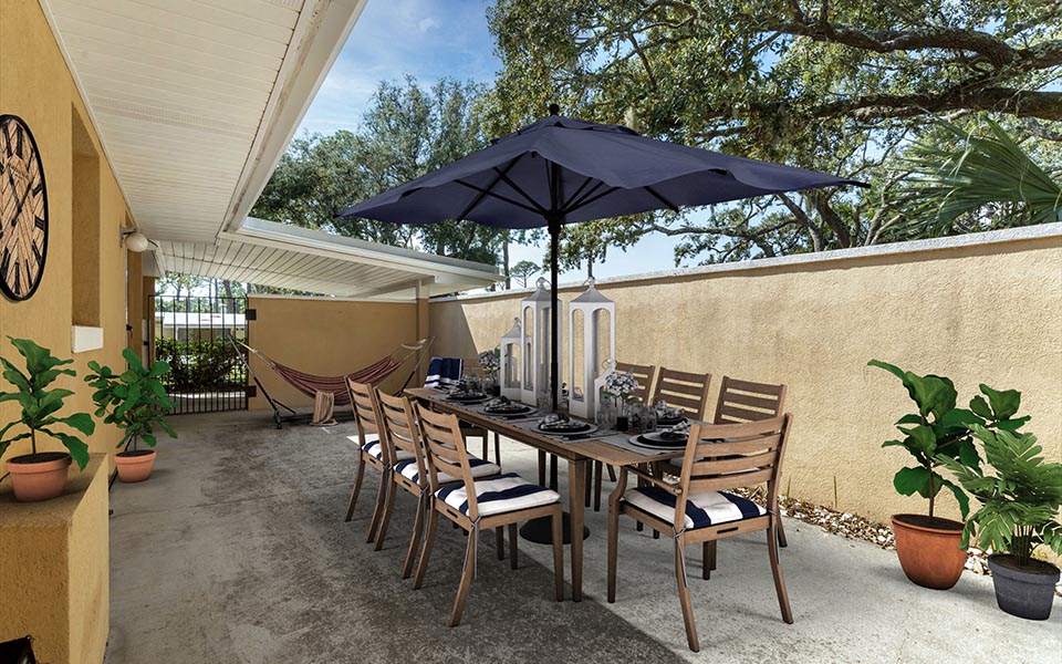 a dining table with an umbrella on a patio