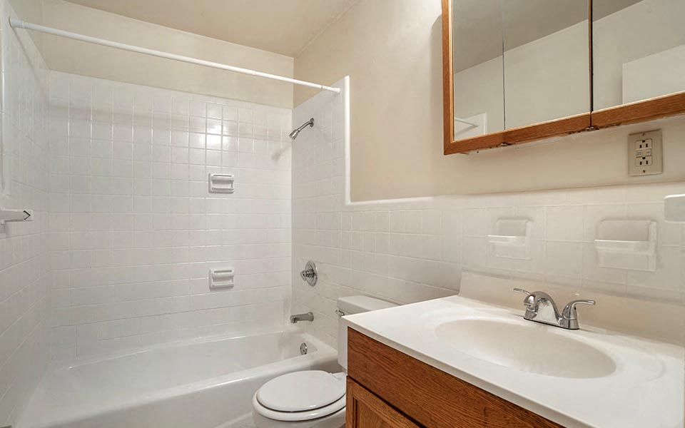 a bathroom with a sink toilet and a bath tub